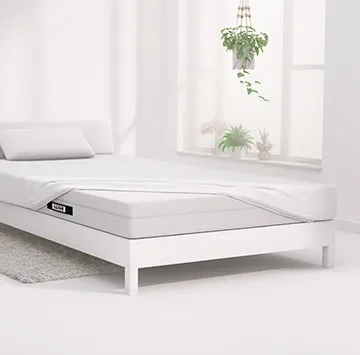 Half of the BODYGUARD® mattress is covered with the jersey fitted sheet in white.