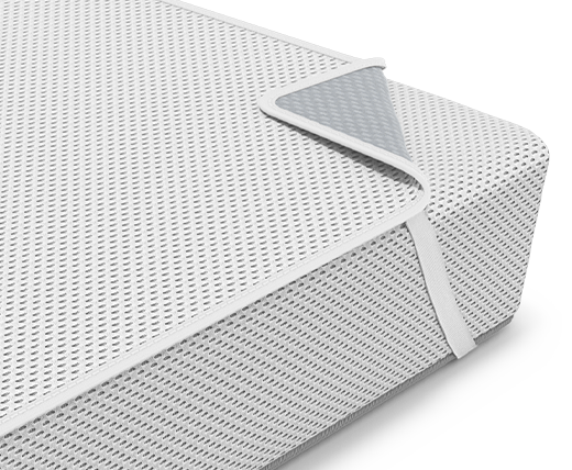 The BODYGUARD® Kids Mattress with the Kids Mattress Protector for children's mattresses on it lies in a cot.	