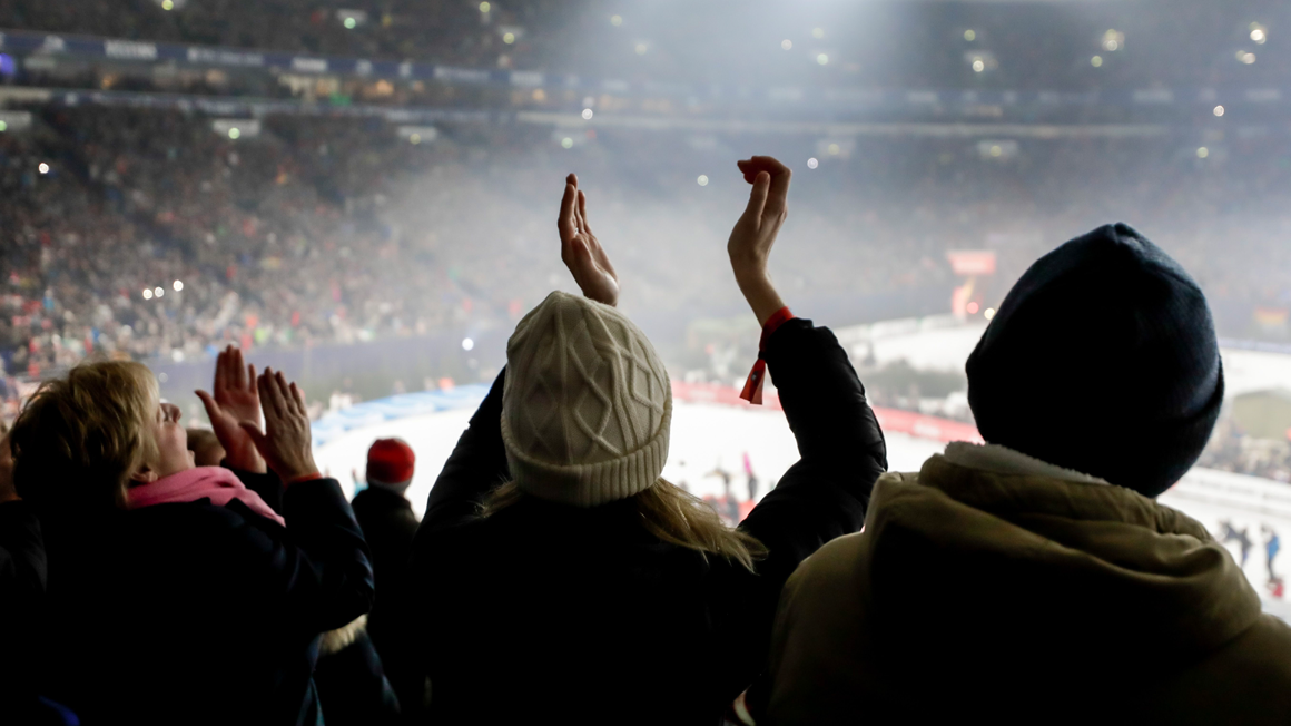Photo: View from the clapping crowd across the stadium, into the stands and onto the pitch.