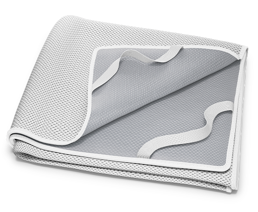 The folded BODYGUARD® Incontinence Pad: a folded-up corner shows the coated underside and the fastening loops.