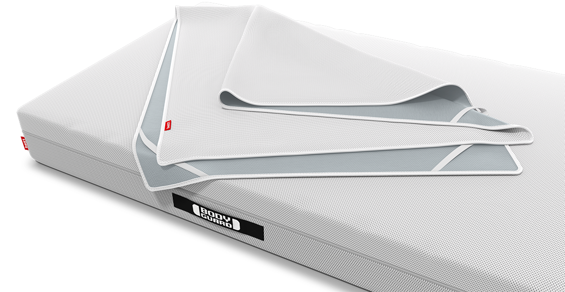 The BODYGUARD incontinence pad lies loosely folded on the BODYGUARD mattress.