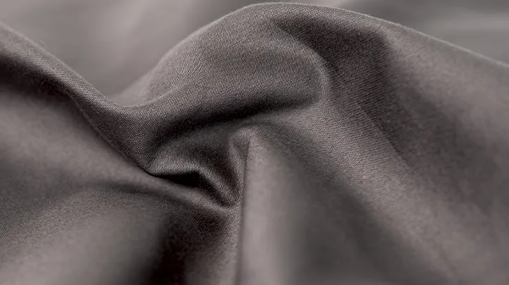 Photo: Close-up view of the smooth structure of a fitted sheet for summer.
