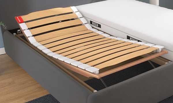 The BODYGUARD Slatted Frame 90x190 with raised head and foot sections inside a bed frame. The BODYGUARD Mattress is placed beside it.