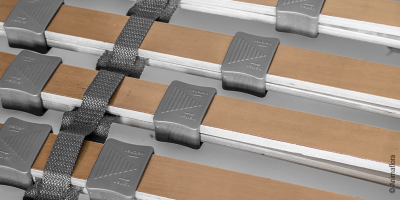 Detailed view of an adjustable slatted frame: focus on spring slats with adjustment sliders