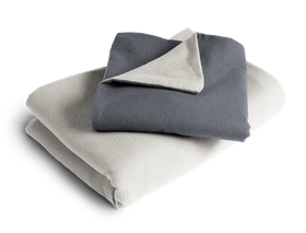 The folded BODYGUARD® Flannel Bed Linen: the duvet cover is folded with the silver side facing outwards, the pillowcase with the anthracite-coloured side	