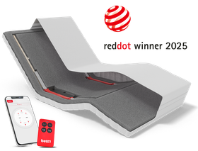 View of HULK with head raised and footrest lowered, with a smartphone and remote control in front. Text: reddot winner 2025.