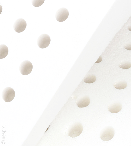 Cut-out of two white mattress cores lying on top of each other with round cut-outs.