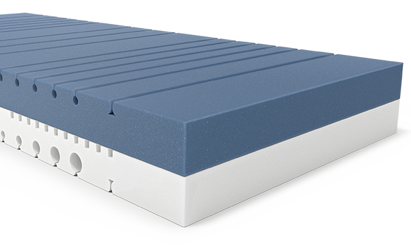 The two-tone mattress core of the BODYGUARD Mattress. The top side is dark and the underside is light. The ergonomic modules are visible as cut-outs and contours in the foam.