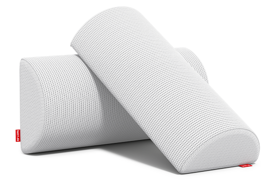 Two knee and neck rolls lie diagonally on top of each other.	