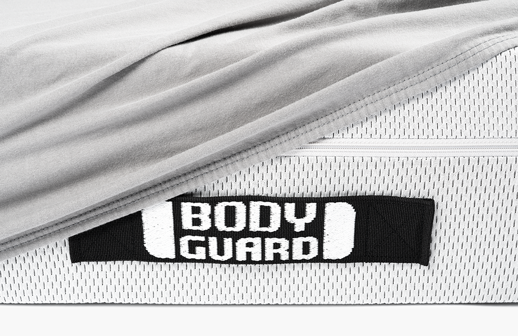  Half of the BODYGUARD® mattress is covered with the jersey fitted sheet in silver.	