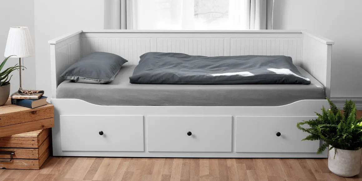 Foto: Ein Couchbett mit Schubladen, darauf Bettzeug mit BODYGUARD Bettwäsche 135x200 cm und Laken bezogen.