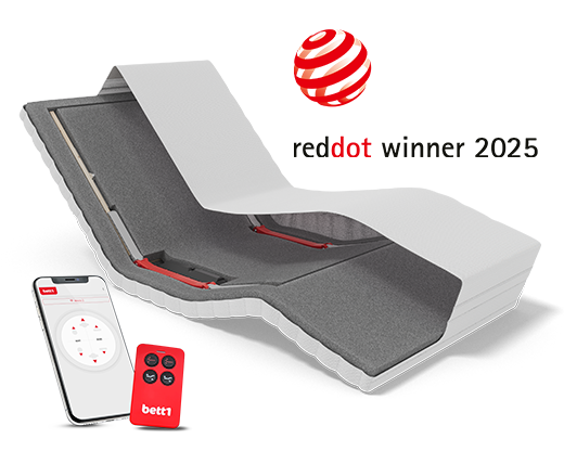 View of HULK with head raised and footrest lowered, with a smartphone and remote control in front. Text: reddot winner 2025.