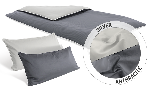 A duvet and two narrow pillows with SOFT BREEZE Satin Bed Linen. A circular inset shows the two colours of the reversible covers: silver and anthracite.
