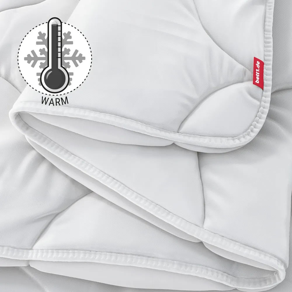 The folded BODYGUARD Winter Duvet warm. Illustration of a thermometer showing a high temperature. Text: warm