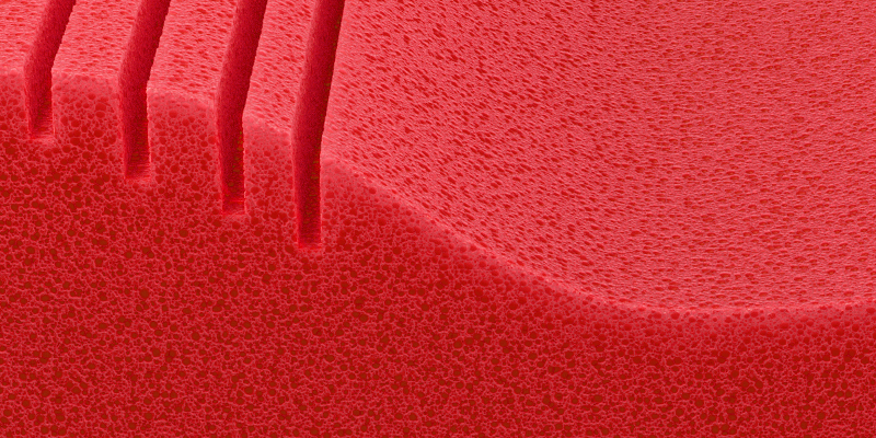 Close-up of the foam core of a BODYGUARD Ergonomic Pillow. Its open-pored structure is clearly visible.
