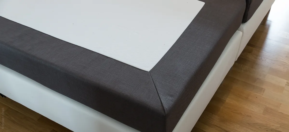 Photo: Corner of a box spring bed frame without a mattress