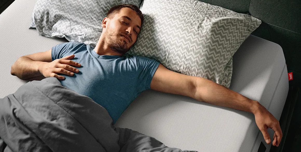 Photo: A person lying on their back on a QXSchaum mattress