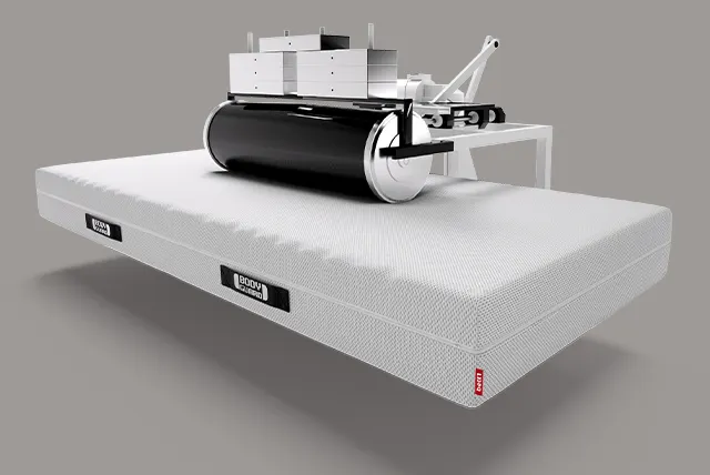 A movable roller with weights lies on a BODYGUARD mattress