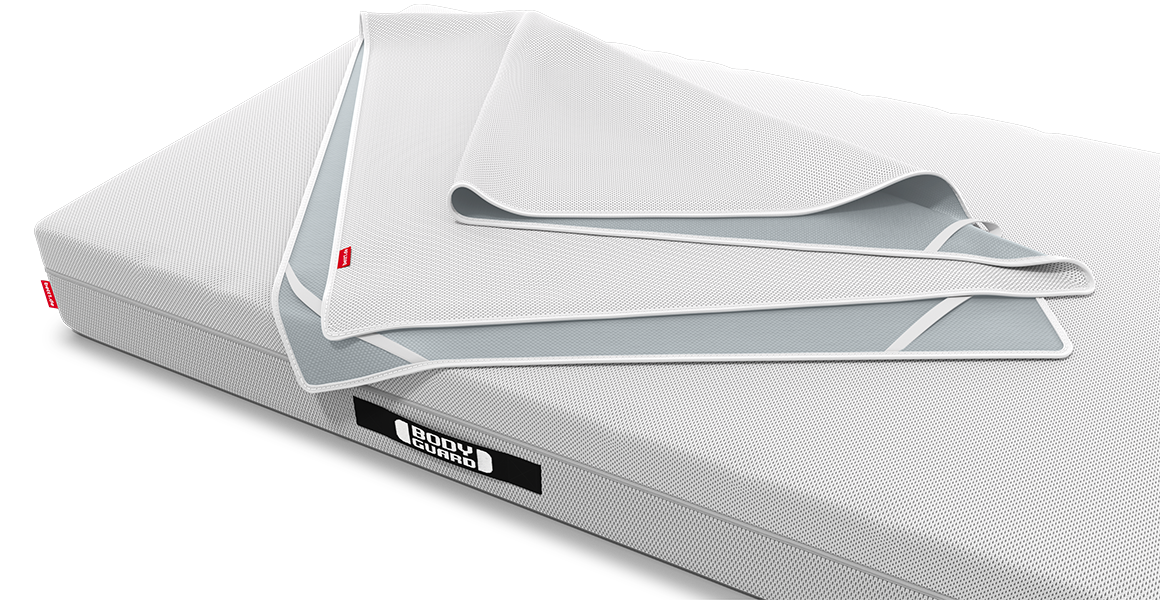 The BODYGUARD incontinence pad lies loosely folded on the BODYGUARD mattress.