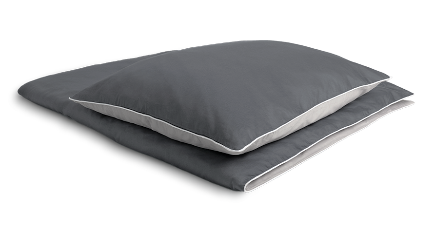 The SOFT BREEZE® Satin Bed Linen covered on a folded duvet with a pillow on it.