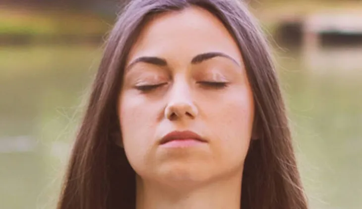 Der Kopf einer Person mit geschlossenen Augen und neutralem Gesichtsaudruck.