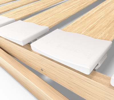Photo: Close-up of the rubber spring caps on the BODYGUARD 80 × 200 cm slatted bed frame. The spring caps rest on the side rail, and the slats are mounted inside the caps.