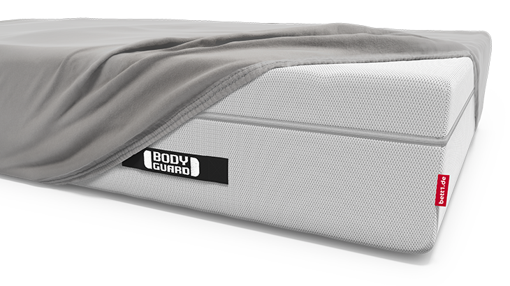 Die BODYGUARD Boxspring Matratze ist bis auf eine Ecke bezogen mit dem BODYGUARD Spannbettlaken extra hoch.