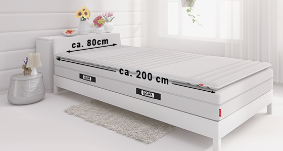 A mattress 80x210 cm lies in a bed. The dimensions are written on the sides.
