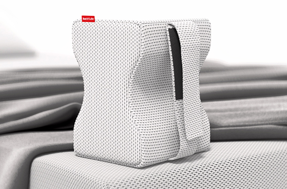 The knee cushion stands upright on the edge of a BODYGUARD® Mattress	