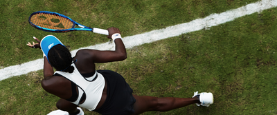 Photo from a bird's eye view: a tennis player with racket in motion.