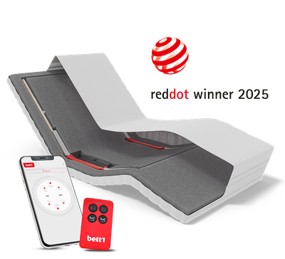 View of HULK with raised headrest and lowered footrest, with a smartphone and remote control in front. Text: reddot winner 2025.