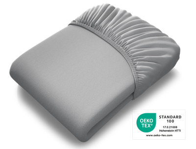  The BODYGUARD® fitted sheet folded up extra high, with the Oeko-Tex® Standard 100 seal on top	
