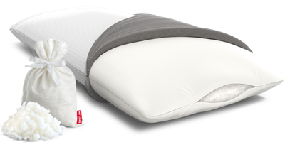 The BODYGUARD Visco pillow half covered. The filling of foam flakes is visible through the slightly open zipper. Next to the pillow are some foam flakes and a storage bag.