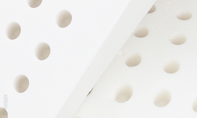 Close-up of a latex mattress with ventilation channels.