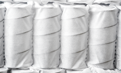 Metal springs sewn into fabric pockets in a pocket spring mattress
