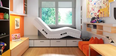 The Hulk with raised headboard and angled footboard lies on a pedestal in a teenager's room. On the left is a shelf with an open laptop. On the right is a desk and a seat cushion.